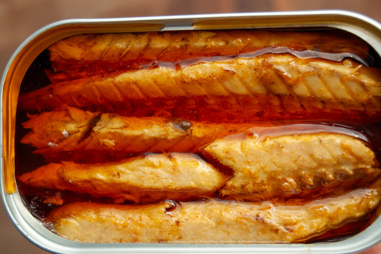 Open tin of mackerel showing the fillet texture